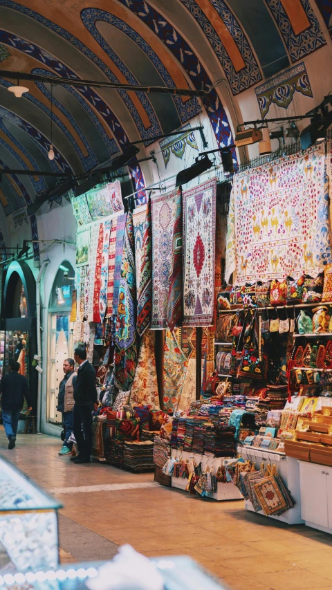 shopkeepers stand near their products at an open market