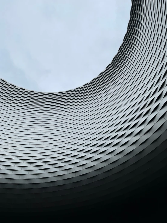 a circular building is shown in the middle of a blue sky