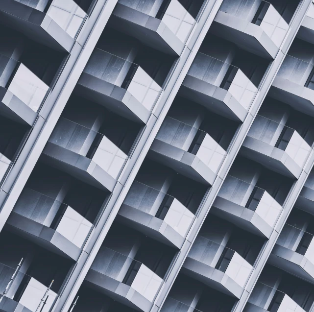 the side of a large, four story building with many windows