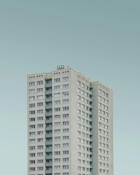 a tall building sitting over a grassy field