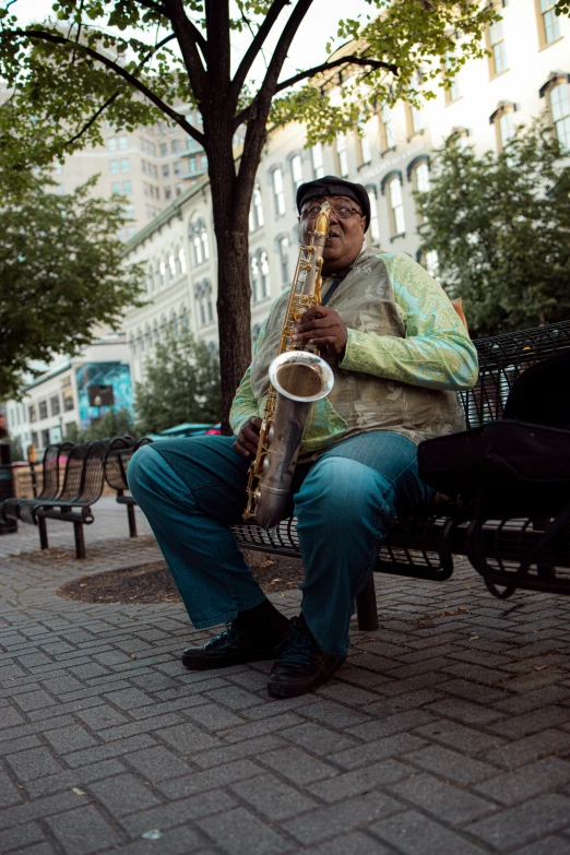 an elderly man playing a saxophone in the street