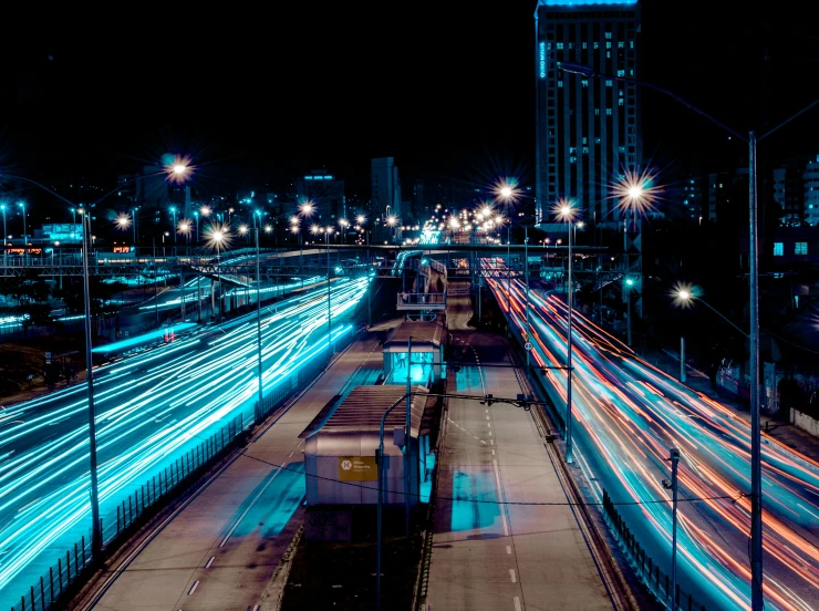 nighttime skyline of highway lanes with illuminated traffic and skyscrs in the distance