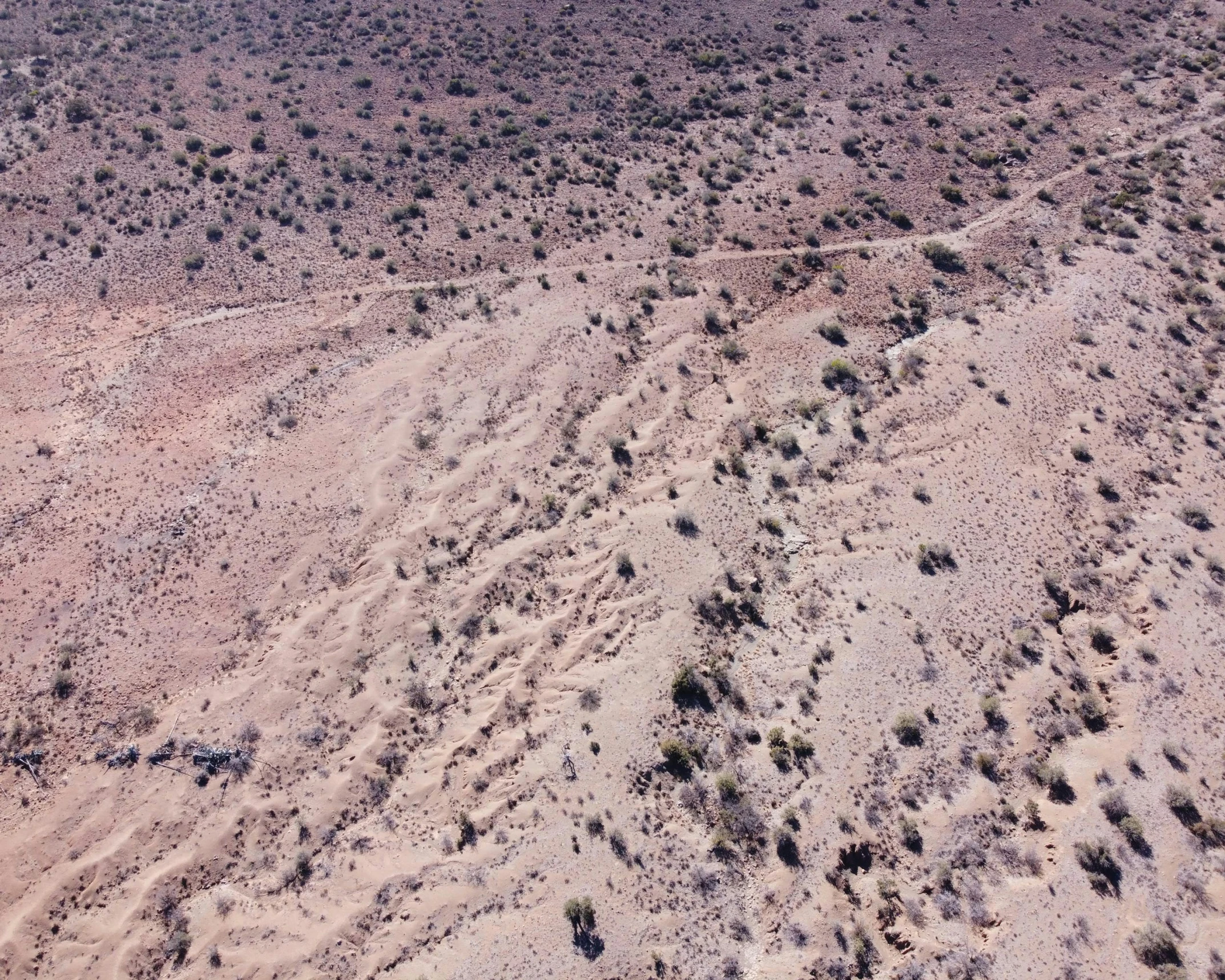 an aerial view of a large hill in the desert