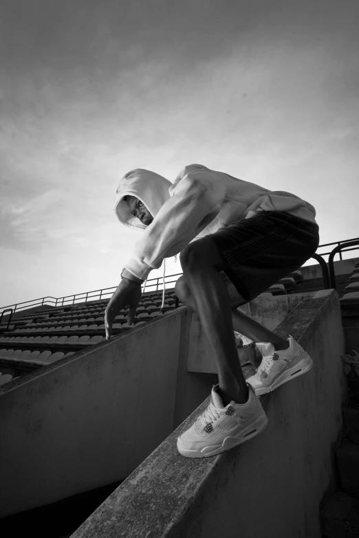 a man riding a skateboard up the side of a cement wall