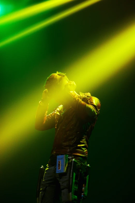 a man standing on top of a stage while holding a microphone