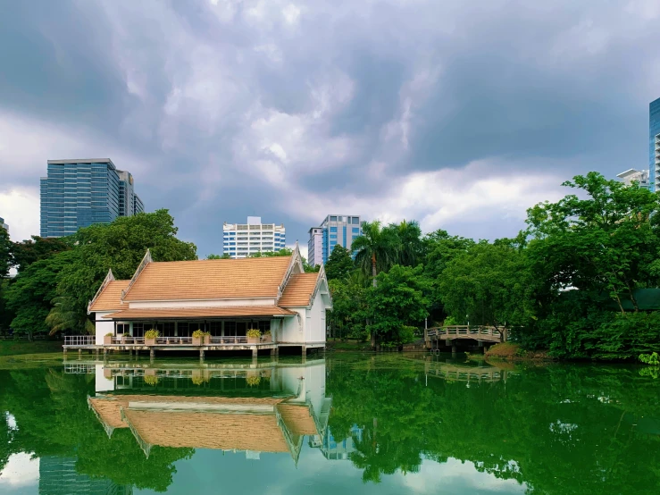 a house sits on the water of a lake