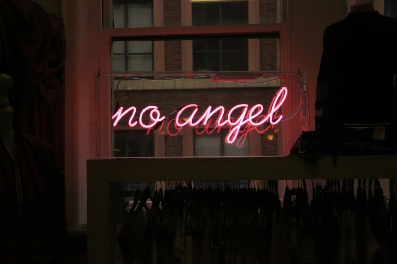 a neon sign that says no angel above a window