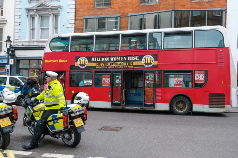 the double decker bus is full of motorcyclists