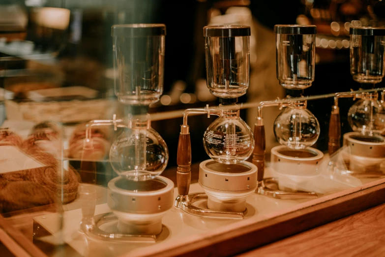 a display case with an assortment of various glass vases on it