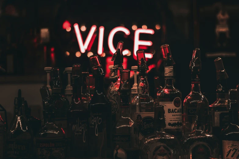 a bar displays various types of booze and liquor bottles