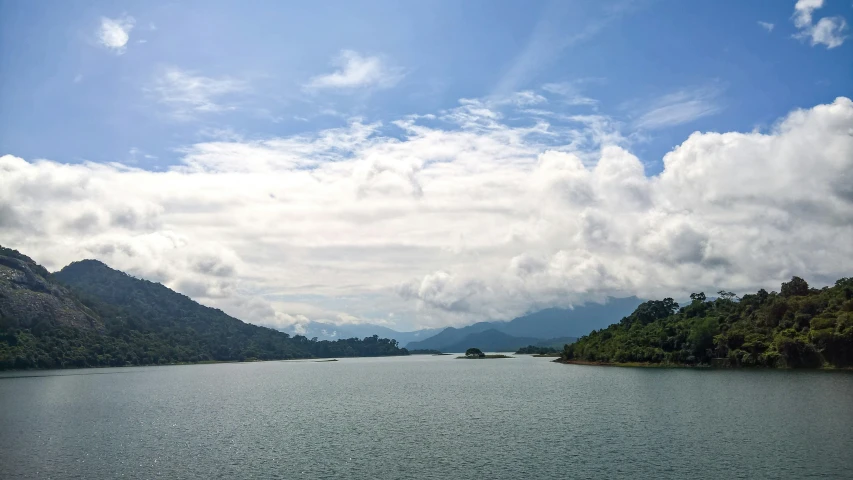 a body of water with mountains in the background