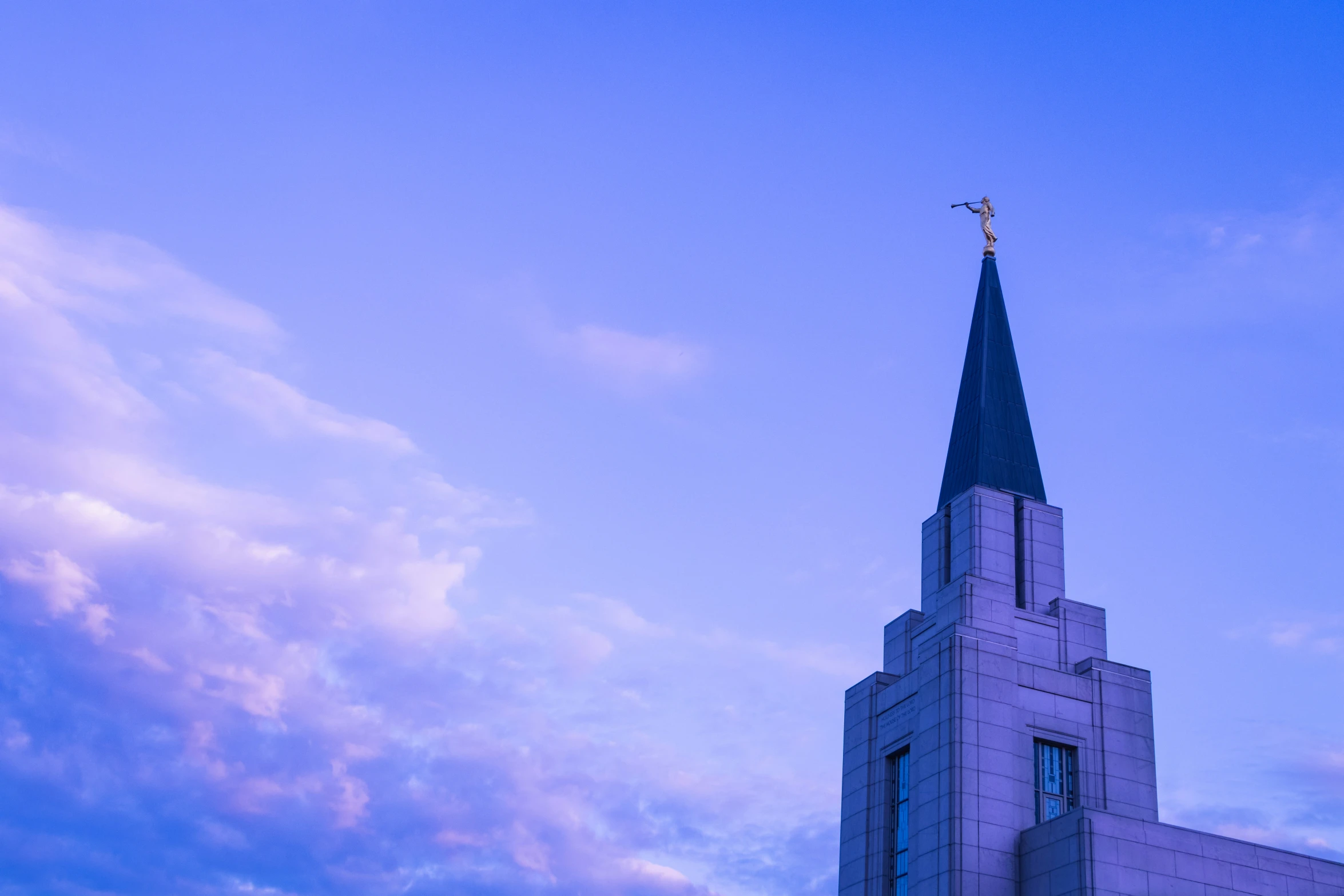 a tall church steeple with a cross on top of it