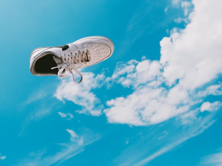 a pair of shoes hanging upside down from the air