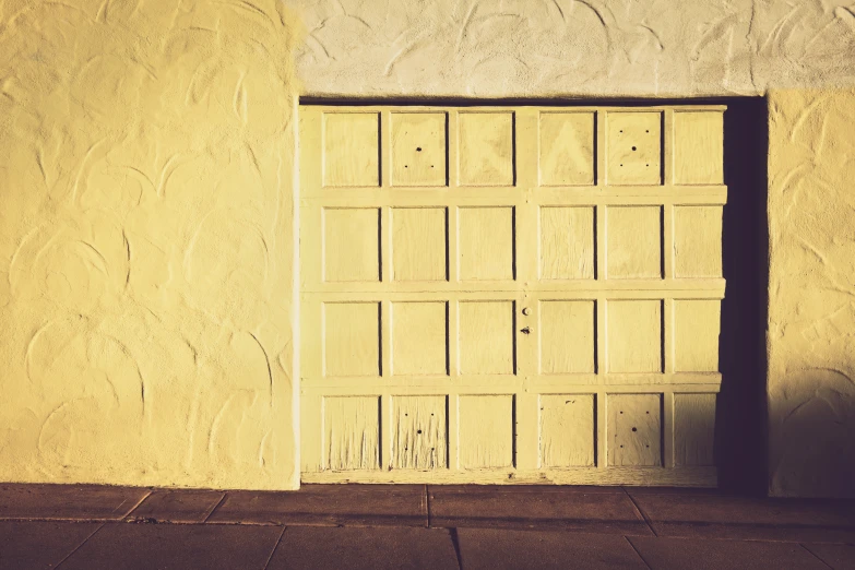 a garage door is open in an adobe building