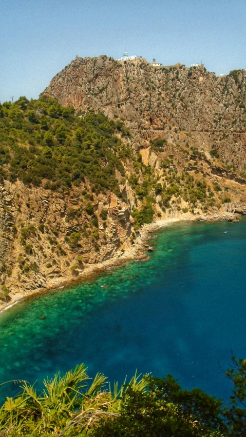 the water is blue with clear green foliage