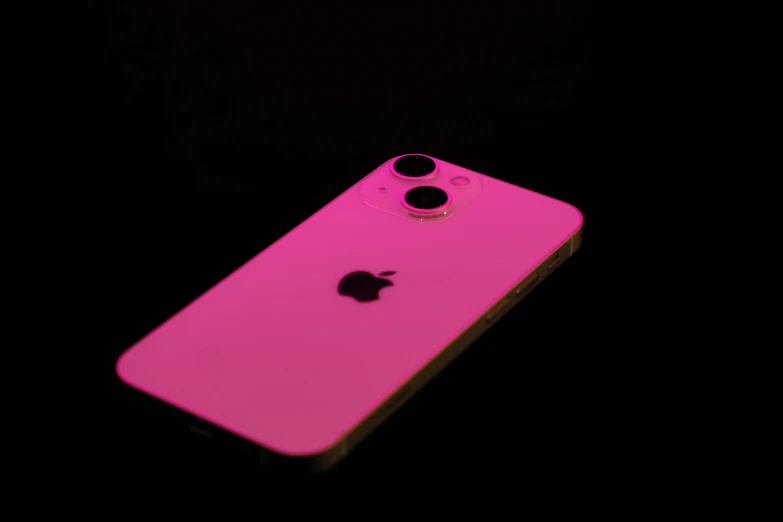 the back end of an iphone that is bright pink