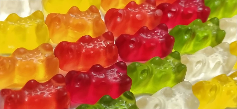 a large group of candy bears that are multicolored