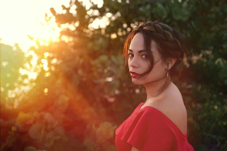 a woman in red dress wearing large earrings