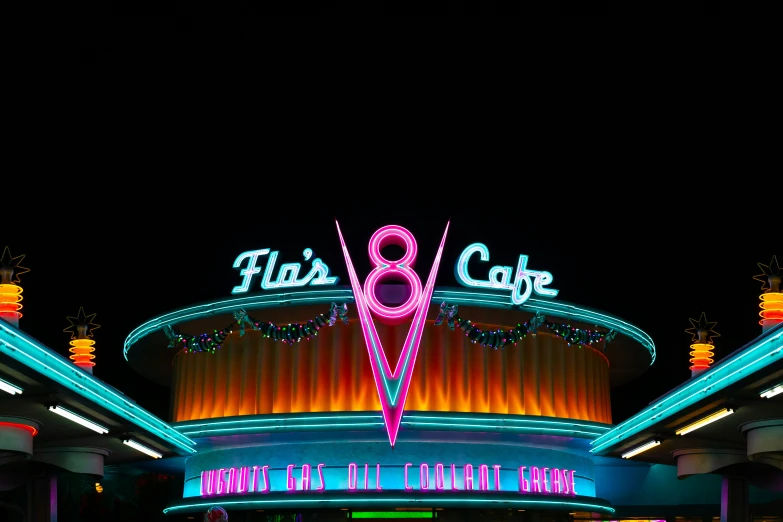 a neon sign at the entrance to a food court