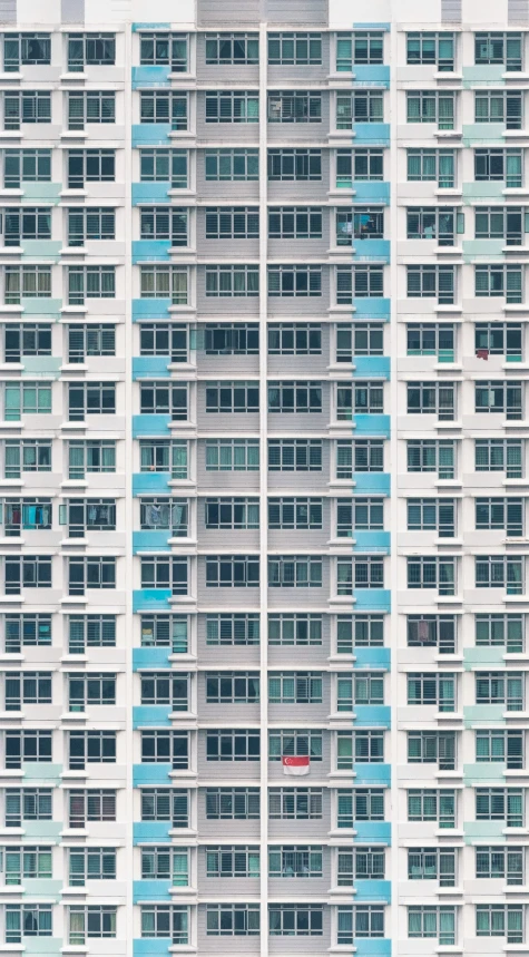 a white building with lots of windows and blue window bars