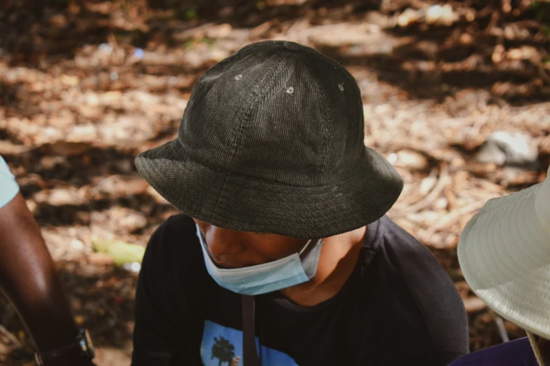 a man wearing a medical mask and hat