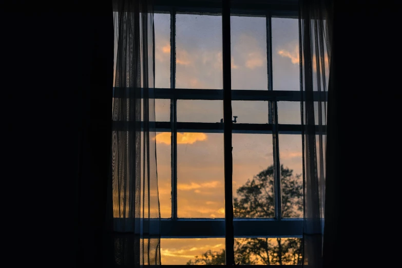 the reflection of the sunset through a window
