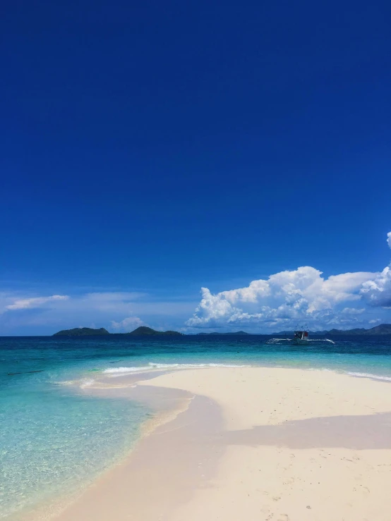 the beautiful ocean is blue with white sand