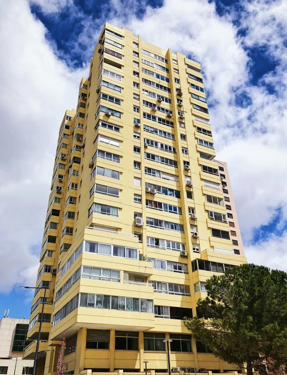 a tall building with windows and an american flag on the top