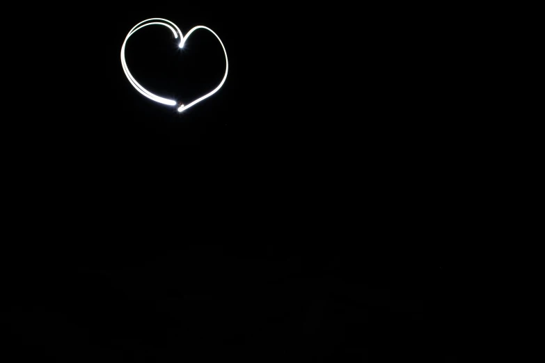 a heart shaped object is shown in the dark