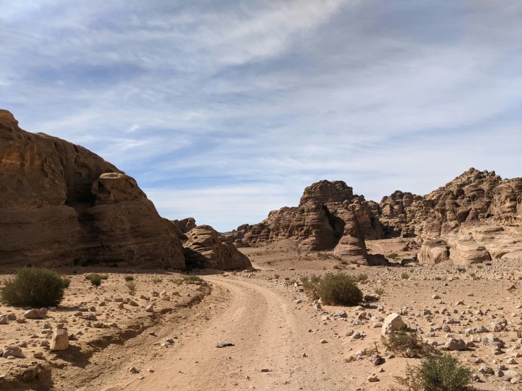 dirt trail surrounded by boulders and other rocks