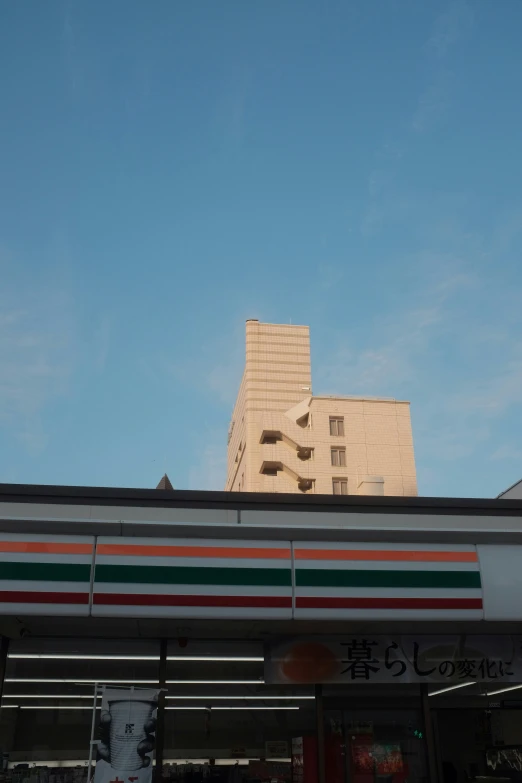 the side of a building with an arch at the top and a small street sign below it