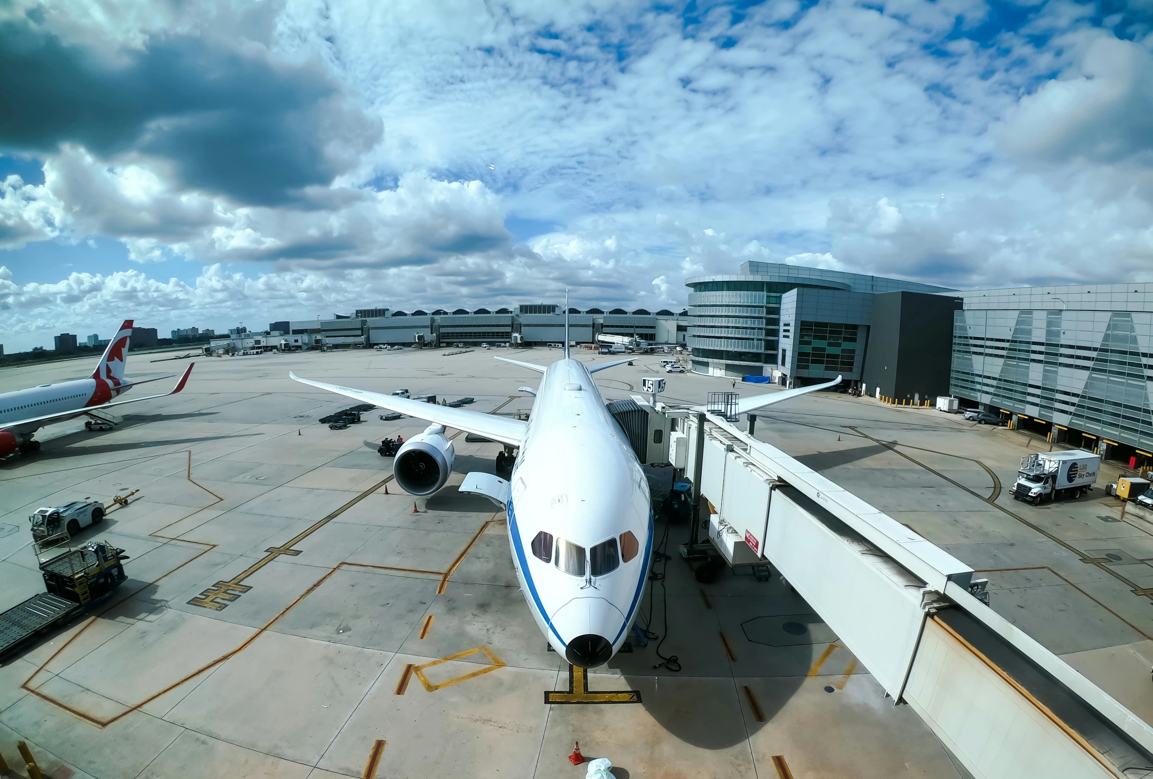 an airplane on the runway with a building behind it