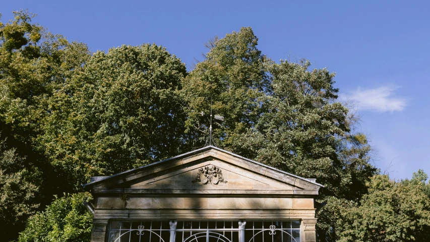 the outside of a church with a clock and fence on the roof