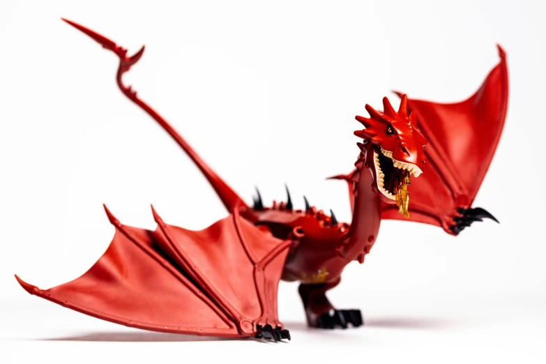 a red dragon statue with spikes on it's wings