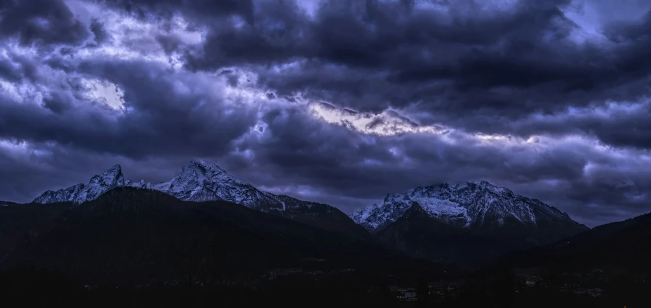 the night sky over mountains and clouds with snow