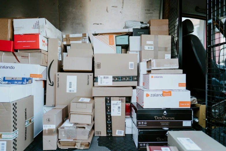 cardboard boxes piled up with papers and folders