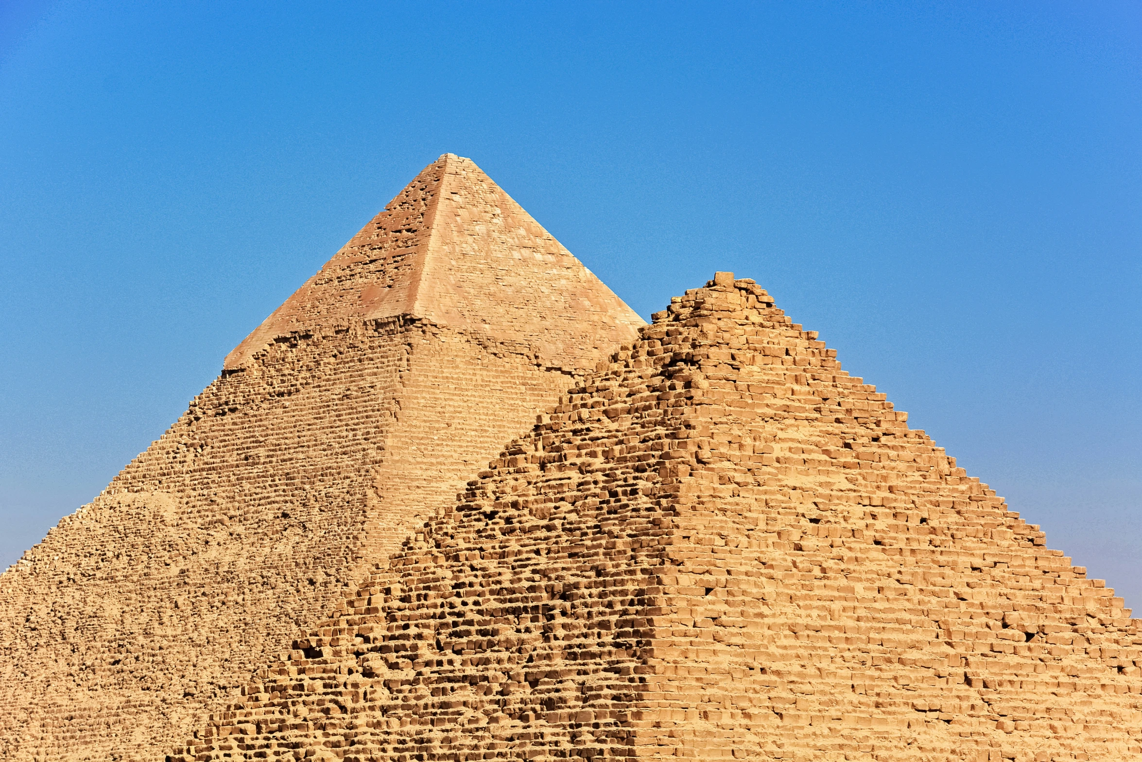 a tall pyramid with a clock in the center of it