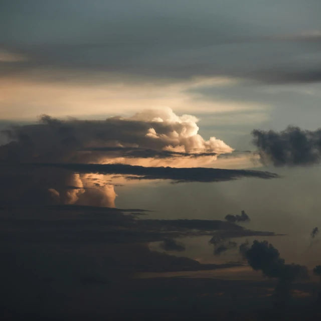 some dark clouds and some white light on the sky