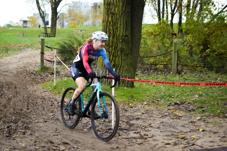 a woman on a bike is going through the mud