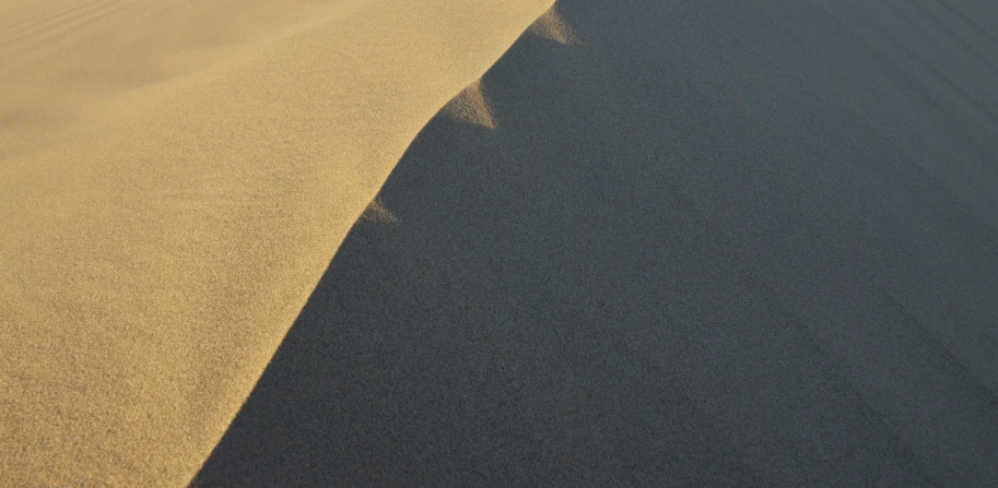 a close up of sand and a sky in the background