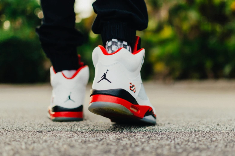 the feet and sneakers of a man in black and white