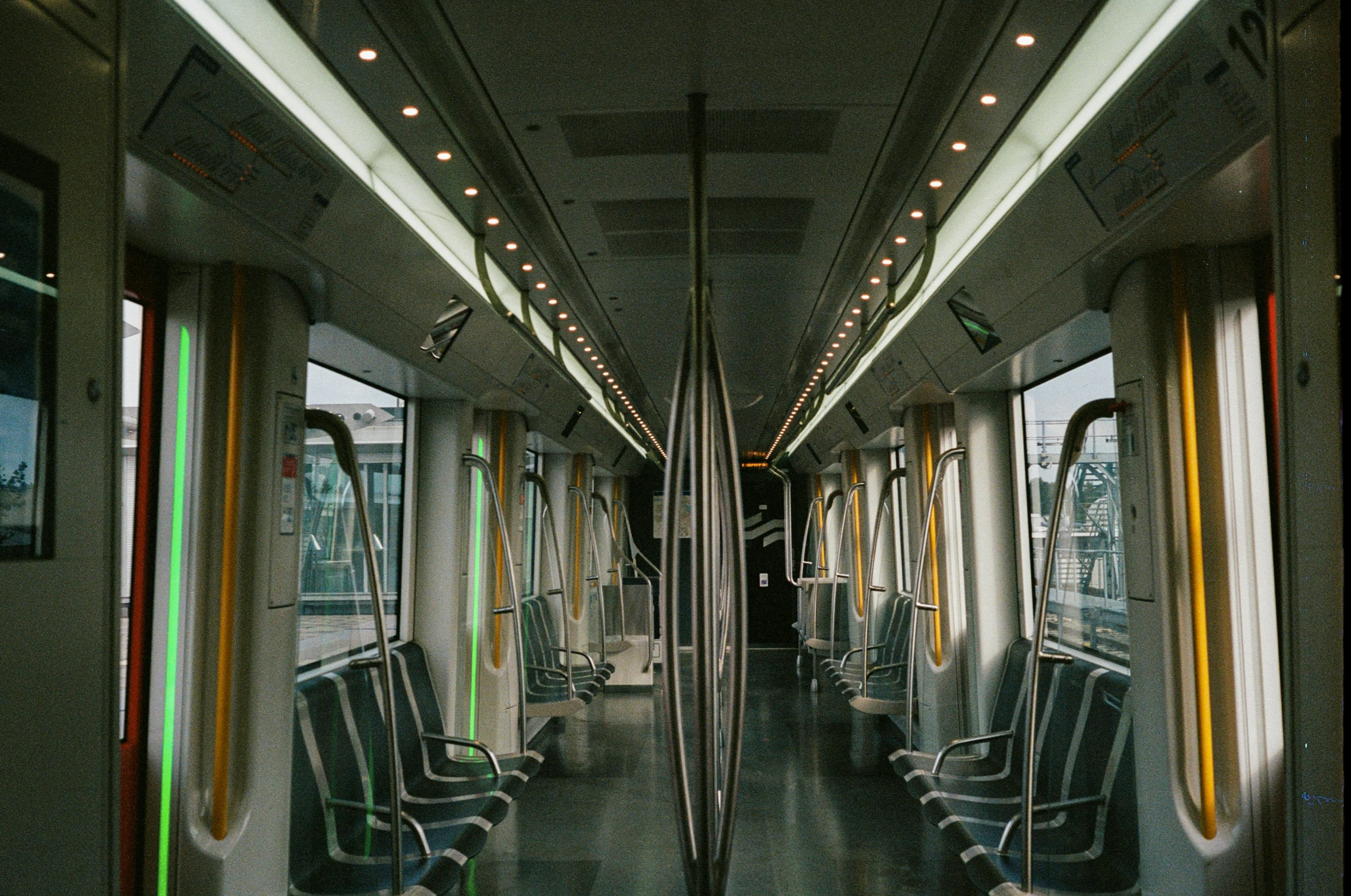 a train car with lots of seats and the windows partially closed