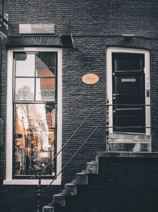 a door a window a step and a sign on a building