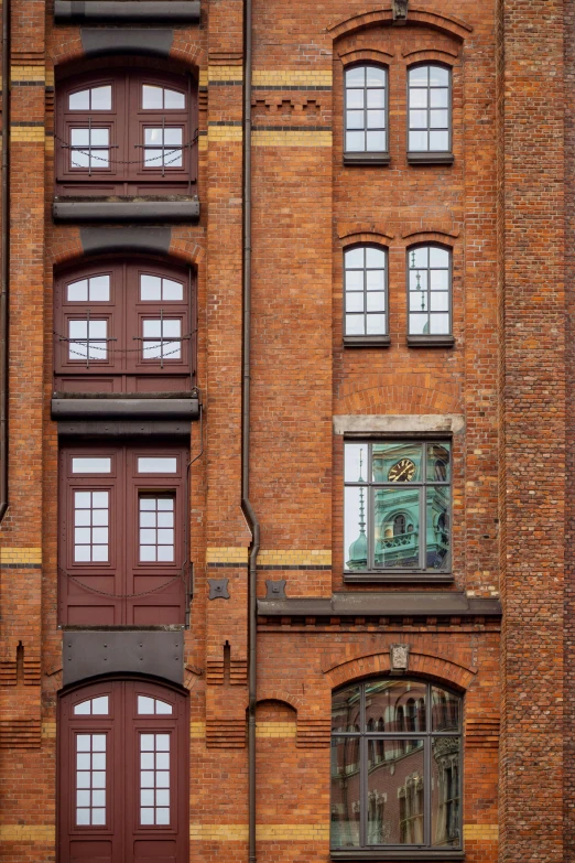 the facade of a brick building with several windows