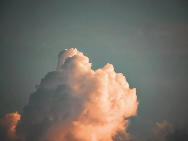 large cloud in the sky, with a airplane