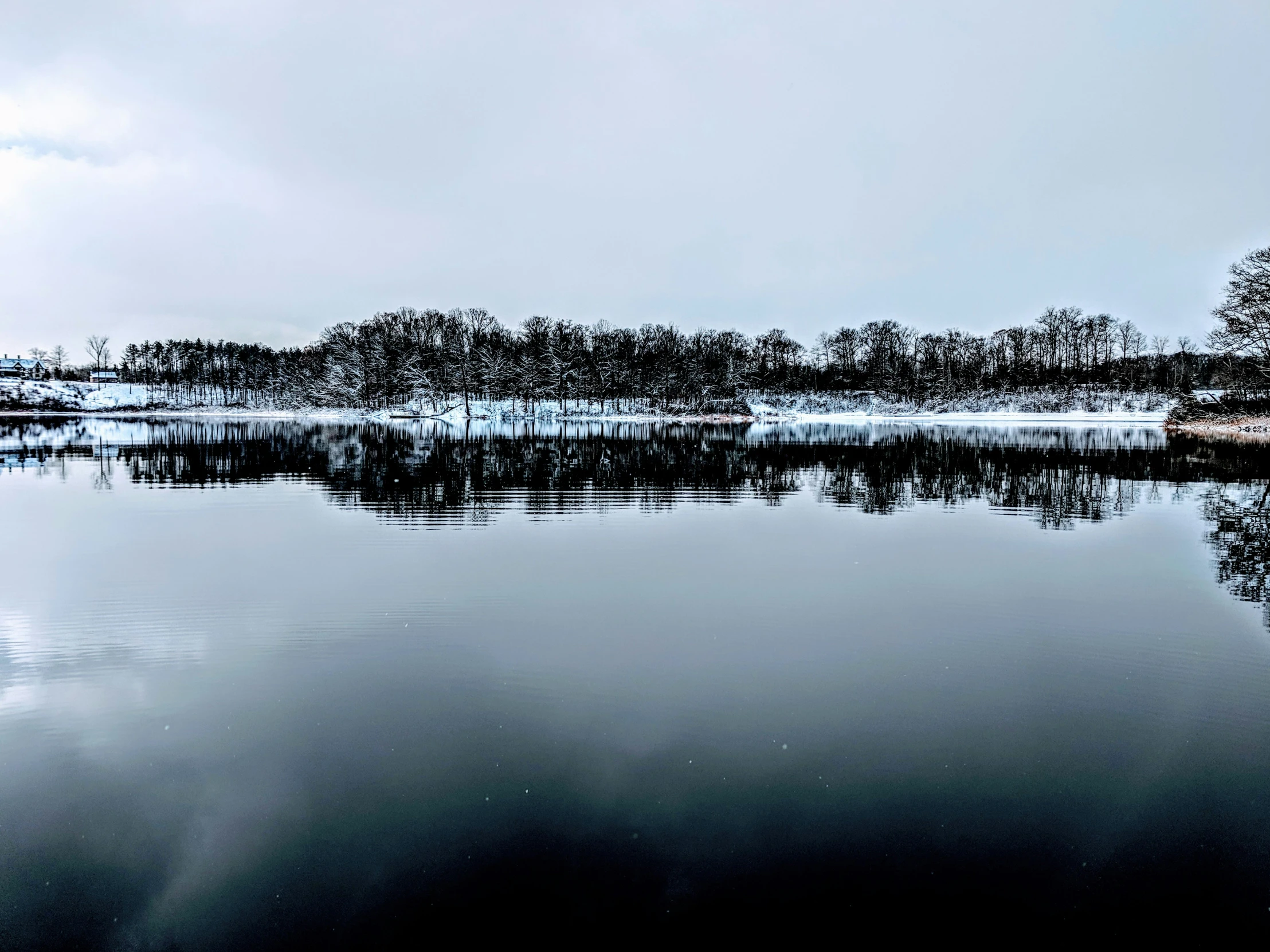 a large body of water sitting under a cloudy sky