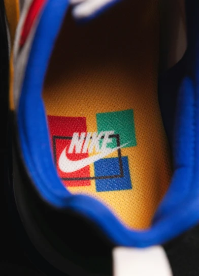 blue nike sneakers with colorful logos