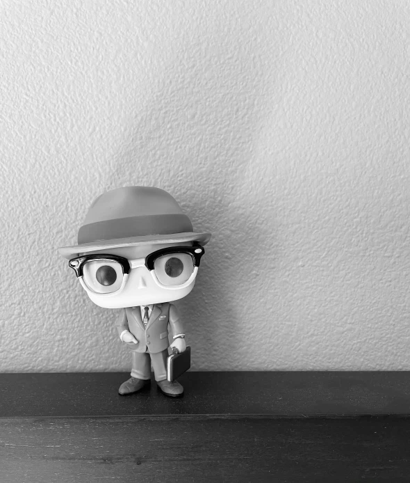 a figurine wearing glasses and a hat