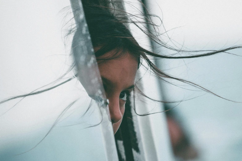 a woman with hair covering her face with long hair