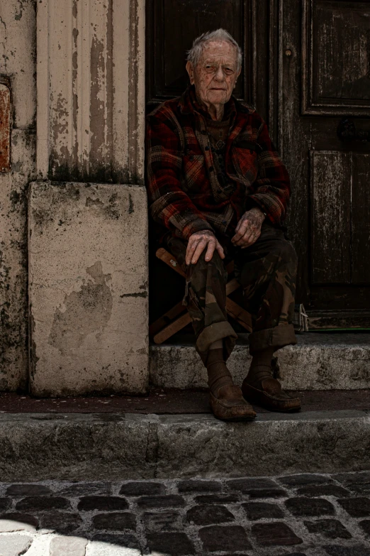 an old man sitting in a chair outside